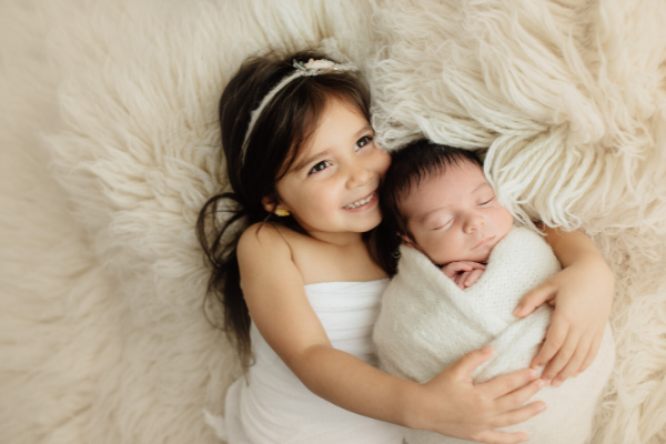 How to Prepare Your Child for a New Sibling | If you're expecting a new baby and need tips on how to share the news with your child - and how to prepare them for the days and weeks after your newborn bundle of joy comes home - this post includes lots of useful information. We've curated 10 age-appropriate books to help start the conversation, as well as tips to consider BEFORE baby arrives, and what to do AFTER your bring the baby home.