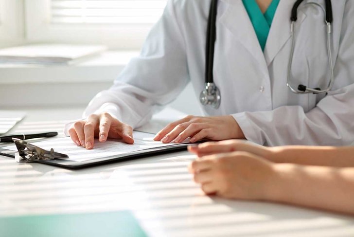 Doctor and patient are discussing something, just hands at the table