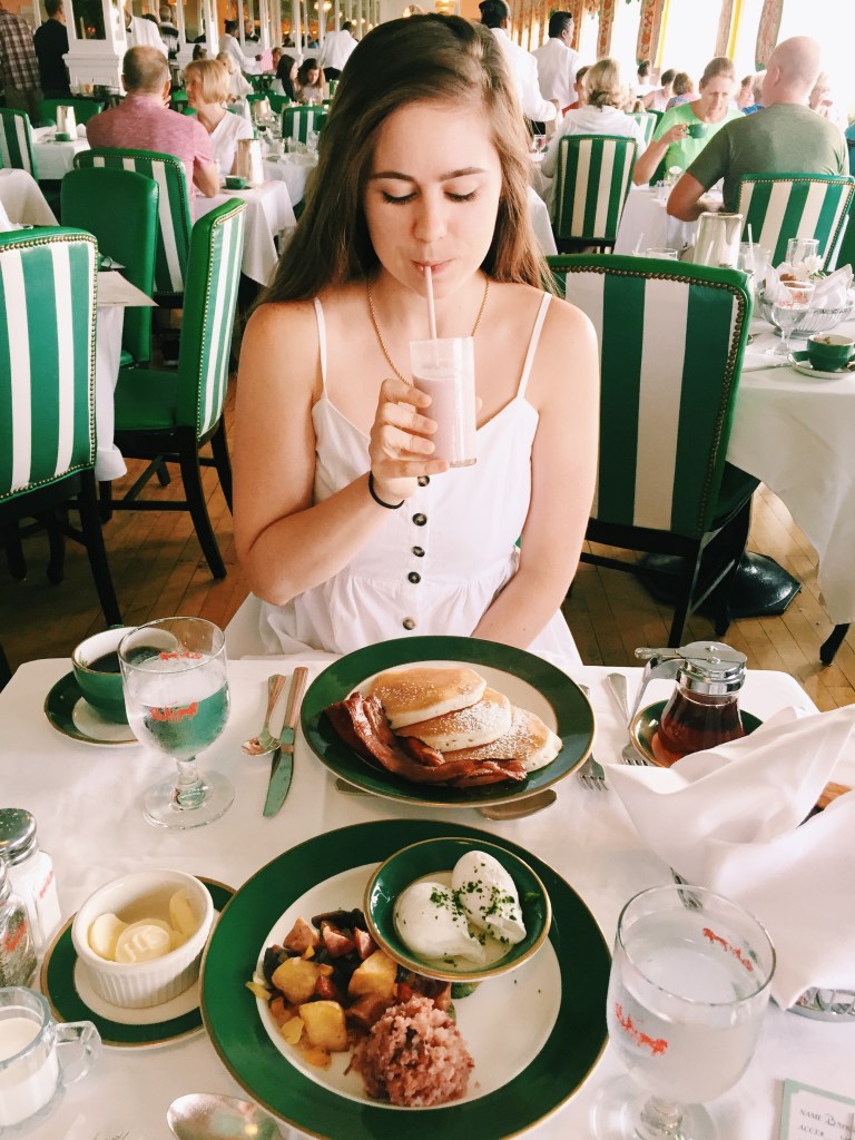 Sarah Bence of Endless Distances sipping a drink before her gluten free meal